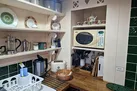 Kitchen area with shelving, microwave, toaster
