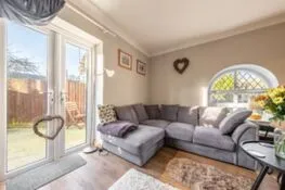 Coach House Cottage: Sitting area  with doors leading into the courtyard